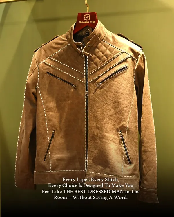 This brown leather jacket showcases our skill in crafting structured outerwear. The design features quilted shoulders and multiple zippers, blending a modern biker aesthetic with bespoke precision.