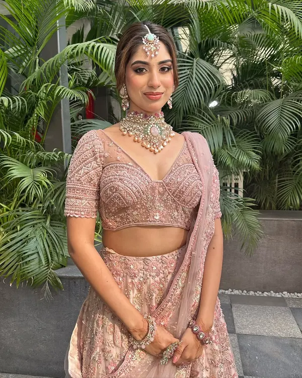 This bride looks like she stepped straight out of a Pinterest board. I created a soft, romantic makeup look and a beautiful textured bun to complement her dusty pink lehenga.