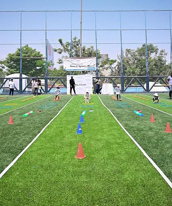 Our annual Sports Meet is a day of fun and friendly competition. Here, the children are participating in a running race, cheered on by their families. The focus is always on participation and trying your best.