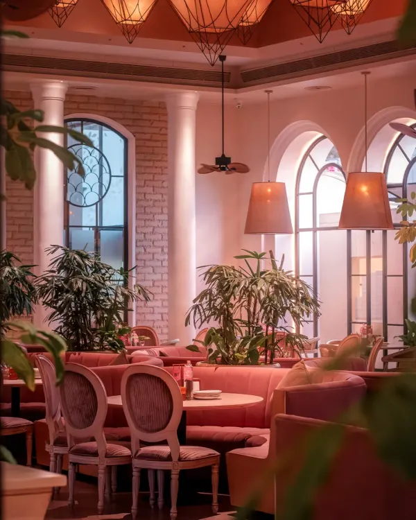 As evening settles, the mansion glows with a warm, inviting light. The combination of plush velvet seating, classic pillars, and ambient lighting creates a cozy yet sophisticated atmosphere for any private event.
