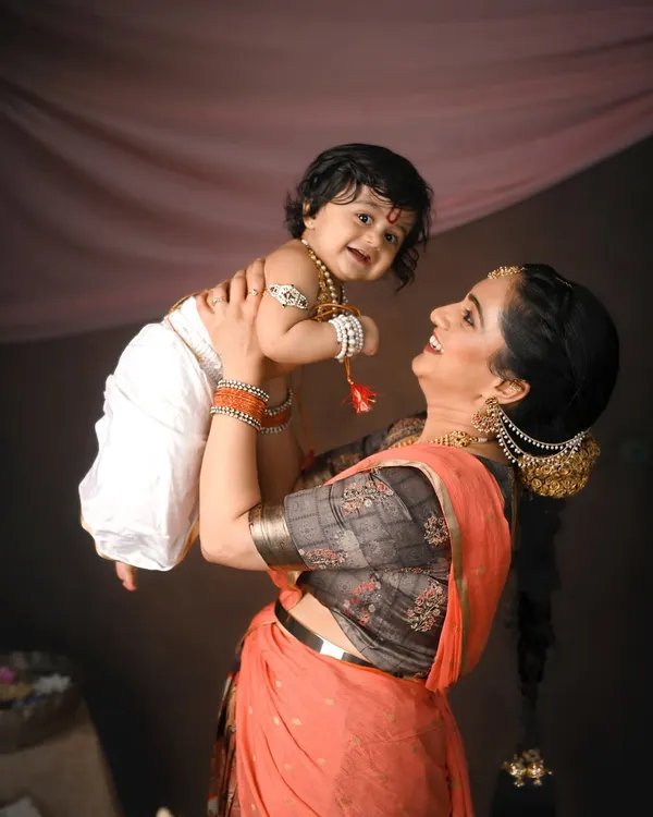 The pure joy of being lifted high by mom. This playful moment between Yashoda and her little Krishna is full of love and laughter.