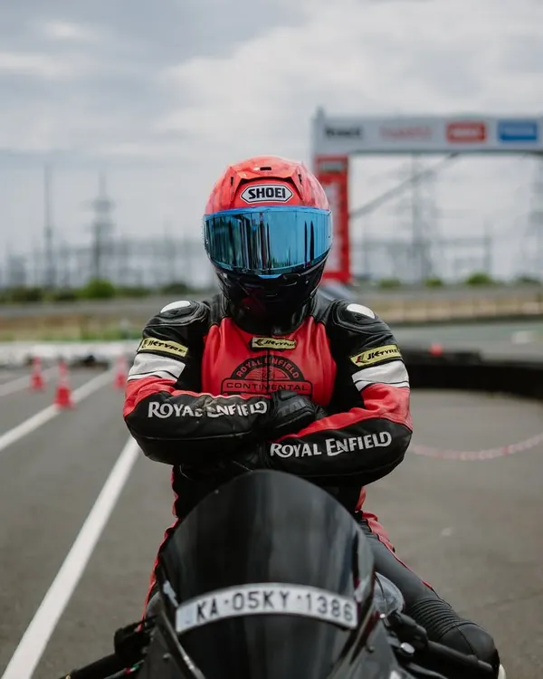 A rider in full gear, focused and ready on the track. This image captures the determination and passion that defines our community.