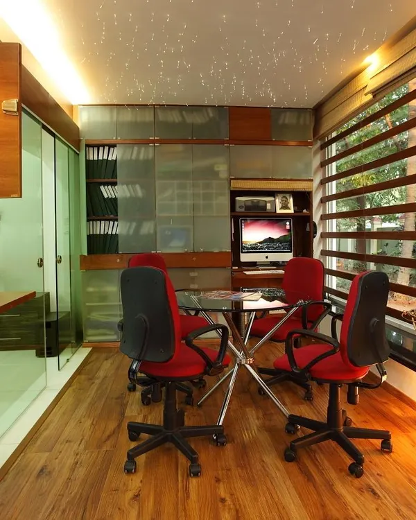 As part of the 'Zingy Home' renovation, we reclaimed an unused balcony to create this functional home office. Enclosed with glass and wood, it provides a dedicated workspace flooded with natural light without sacrificing the feeling of openness.