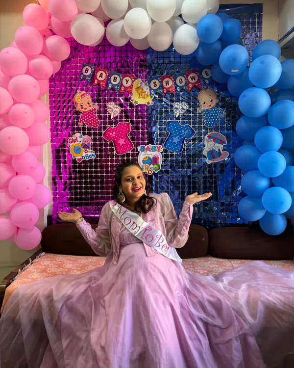The perfect dress for a gender reveal party. This client is wearing our lavender gown and a "Mom to Be" sash, ready to celebrate the big news.