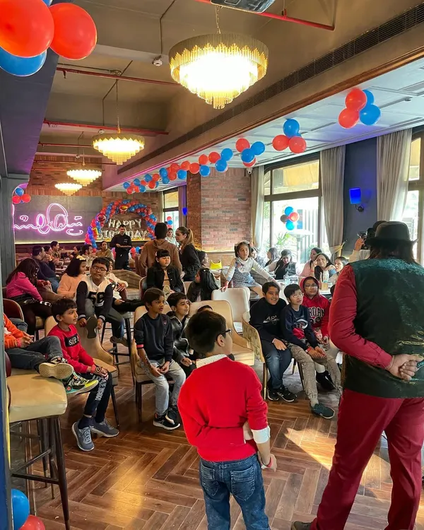 A magician captivating an audience of kids and adults at a birthday party. My entertainment services are designed to keep guests of all ages engaged and amazed.