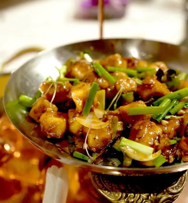 A classic dish from Tangra, Kolkata's Chinatown, served in a traditional kadai. We specialize in bringing authentic regional Indian-Chinese flavors to your wedding menu.