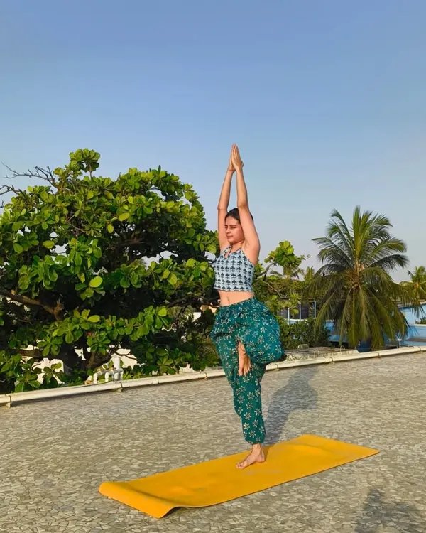 Finding stillness and strength in Vrikshasana (Tree Pose) on the rooftop. This balancing pose improves focus and concentration while grounding your energy.