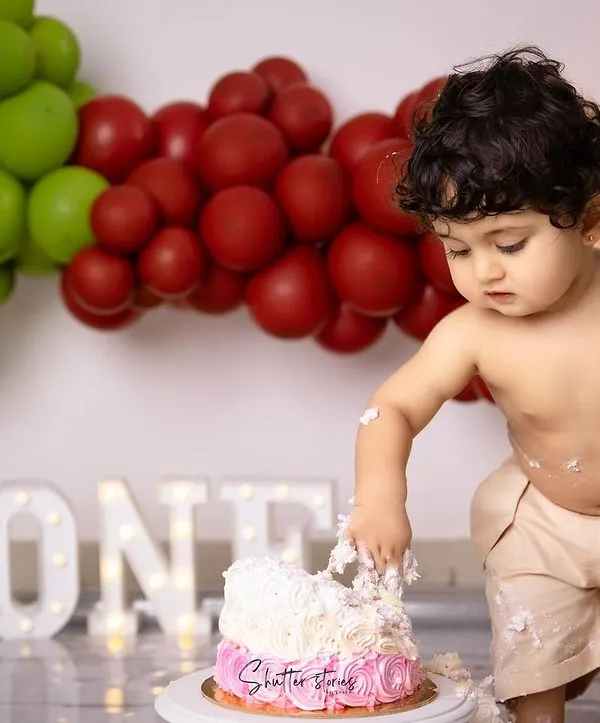 The sweetest milestone and the messiest memories! This little guy is having a blast digging into his first birthday cake.