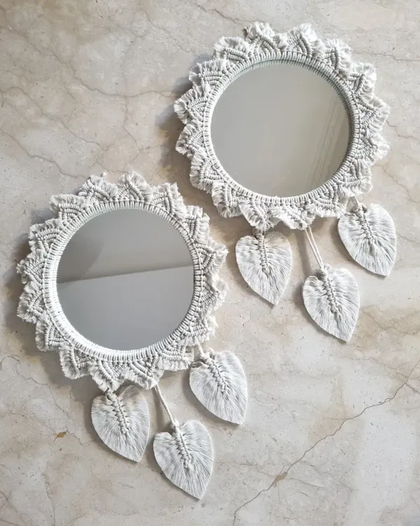 Add a touch of artisan charm to your space with these white macrame mirrors. The intricate knotting and leaf details make them a beautiful and functional addition to any wall.