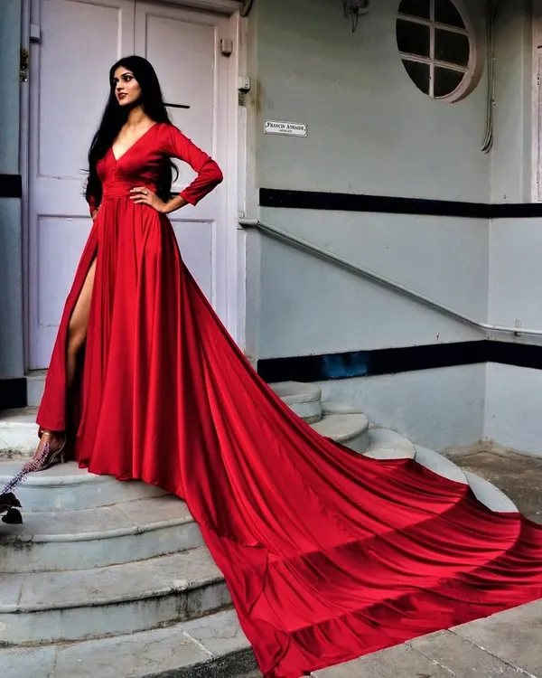 Be the sultry siren in our liquid silk gown. This red gown features a thigh-high slit and a massive, flowing trail that looks incredible in photos.