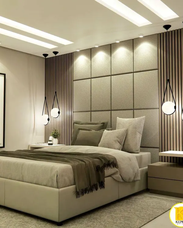 A luxurious master bedroom featuring a floor-to-ceiling upholstered headboard, flanked by vertical wood slats and modern pendant lights. This design creates a warm, sophisticated, and hotel-like ambiance.