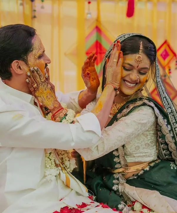 A joyful, candid moment as the bride and groom playfully apply haldi to each other. This is the kind of happy chaos I love to capture.