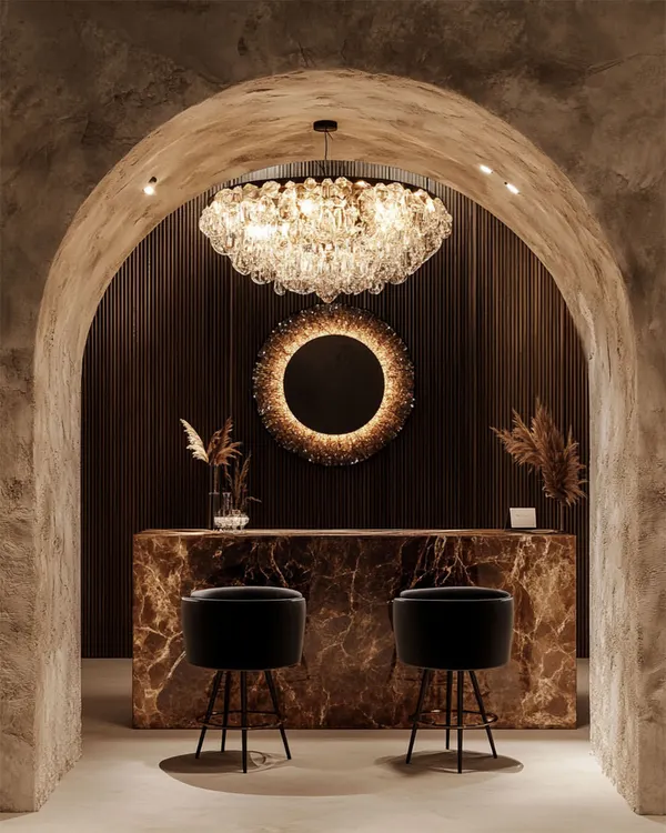 I believe lighting is the soul of a room. Here, a magnificent crystal bubble chandelier transforms this bar nook into an intimate, opulent escape, with its warm light reflecting beautifully against the marble and dark wood. This is the kind of mood-setting centerpiece I love to create for my clients.