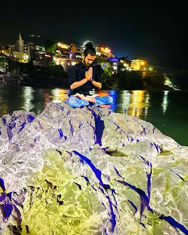 A moment of peace and meditation by the Ganga in Rishikesh at night. Connecting with nature and stillness is the essence of yoga.