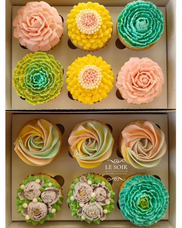 A whole garden of eggless cupcakes. This shows the variety of floral designs I can create using my less-sweet buttercream, from delicate rosettes to vibrant, multi-layered blossoms. Each one is piped by hand.