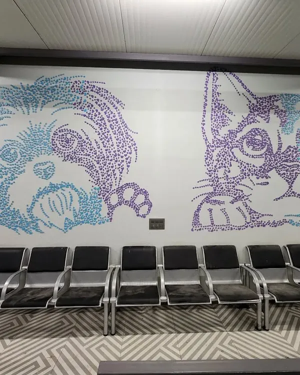 The completed double mural for the Chasing Tails waiting area. We used thousands of small, heart-shaped MDF cutouts in blue and purple to render these friendly cat and dog portraits.