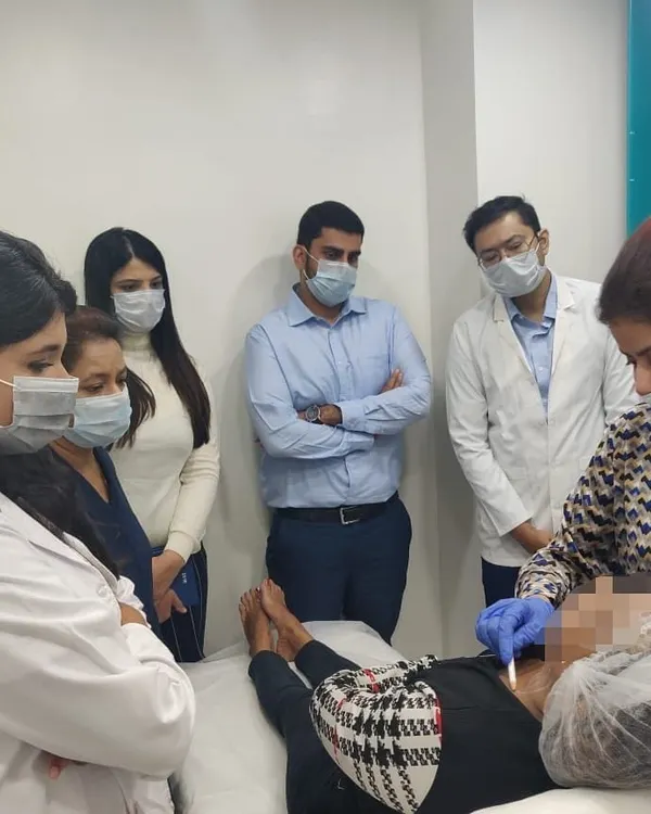 Hands-on training sessions are vital for staying at the forefront of dermatology. Here, I'm observing a procedure with colleagues, always learning and refining our techniques.