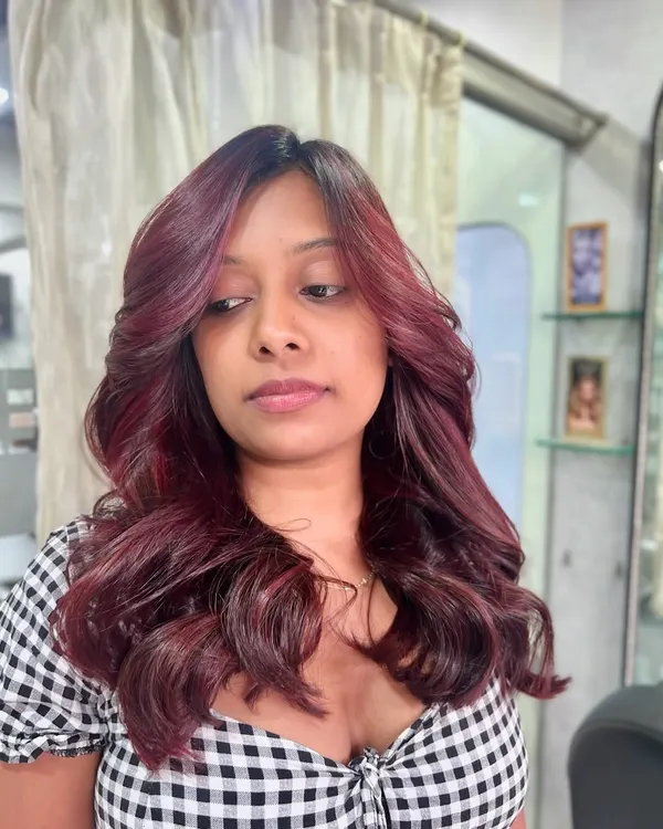 Who says hair can’t make a statement? This fiery red look is bold, vibrant, and full of personality, styled with soft waves to show off the rich dimension.