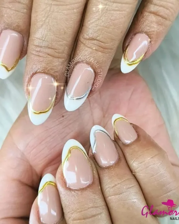 A sophisticated and modern take on the French manicure. This design features a classic white tip with a delicate gold and silver line tracing the curve for a touch of metallic elegance.