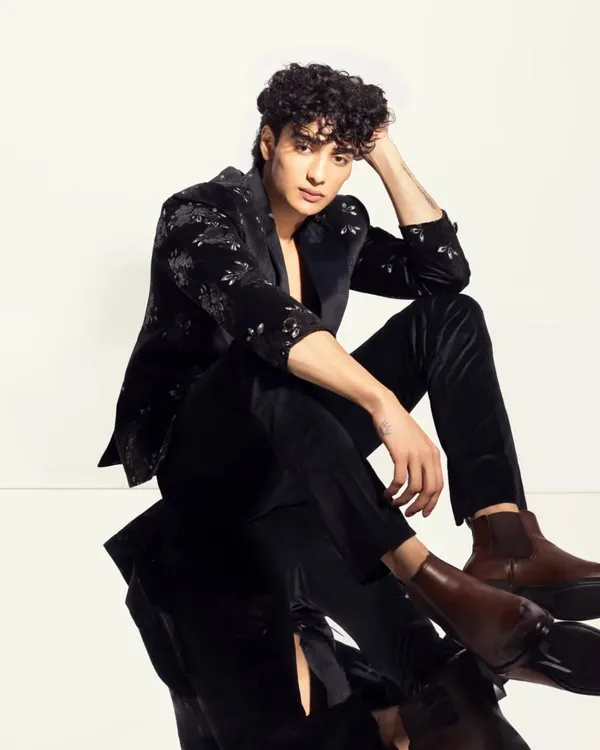 For this men's fashion shoot, I focused on defining his features with subtle contouring and grooming his curly hair to create a polished yet natural look.
