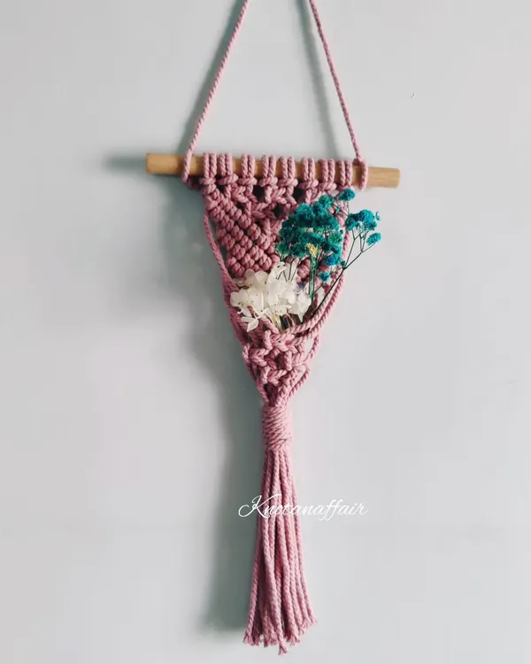 A lovely macrame mini plant hanger, perfect for a car, a doorway, or a nursery wall. You can decorate it with dried flowers, succulents, or air plants.