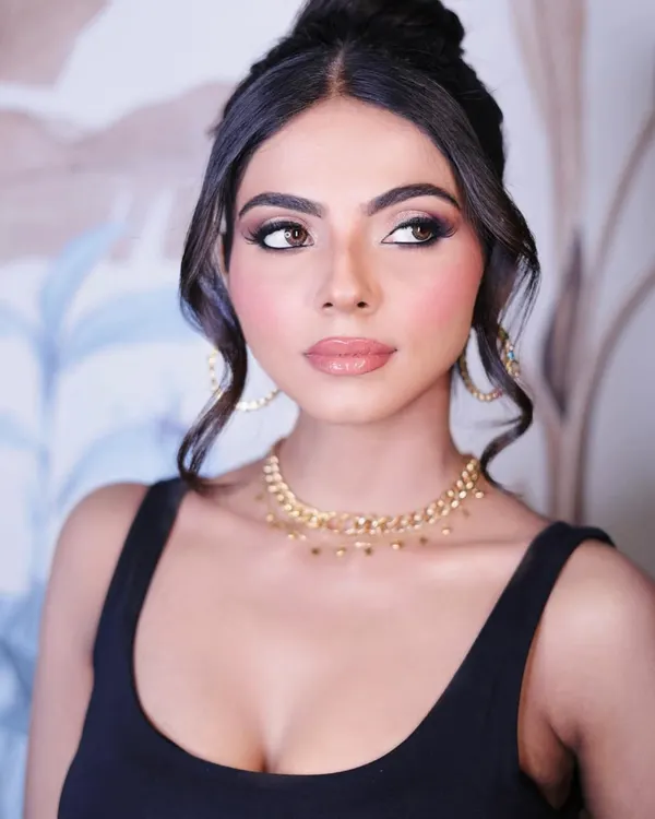 A sophisticated party look. This soft glam style features beautifully blended smokey eyes, glowing skin, and a glossy nude lip, perfect for any elegant evening event.
