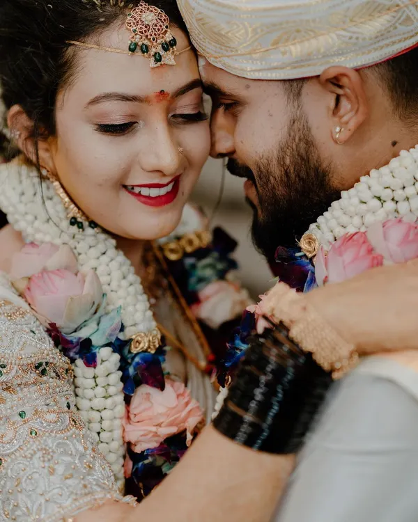 A tight, emotional close-up of a South Indian couple during their wedding ceremony, sharing a moment of pure joy. Capturing these candid, heartfelt interactions is a cornerstone of our documentary approach.
