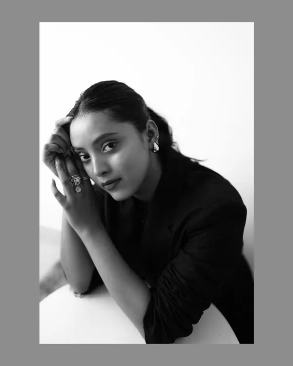 A classic black and white portrait where the simplicity of the composition emphasizes the model's striking features and direct gaze. This timeless style is perfect for actor headshots or fashion portfolios.