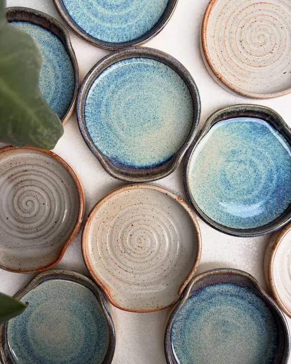 Our spoon rests are always in high demand. This overhead shot shows the beautiful variety of our studio-mixed glazes, including the drippy rutile and earthy shino finishes. Each one is a small piece of functional art for your kitchen.
