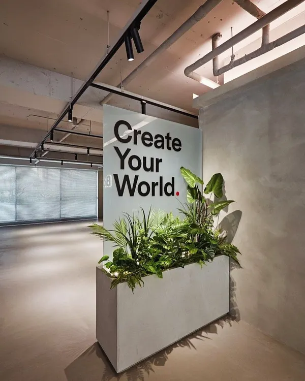 A great example of biophilic design in a commercial space. This large concrete planter acts as a natural divider and a green focal point, bringing life and fresh air into a modern office lobby.