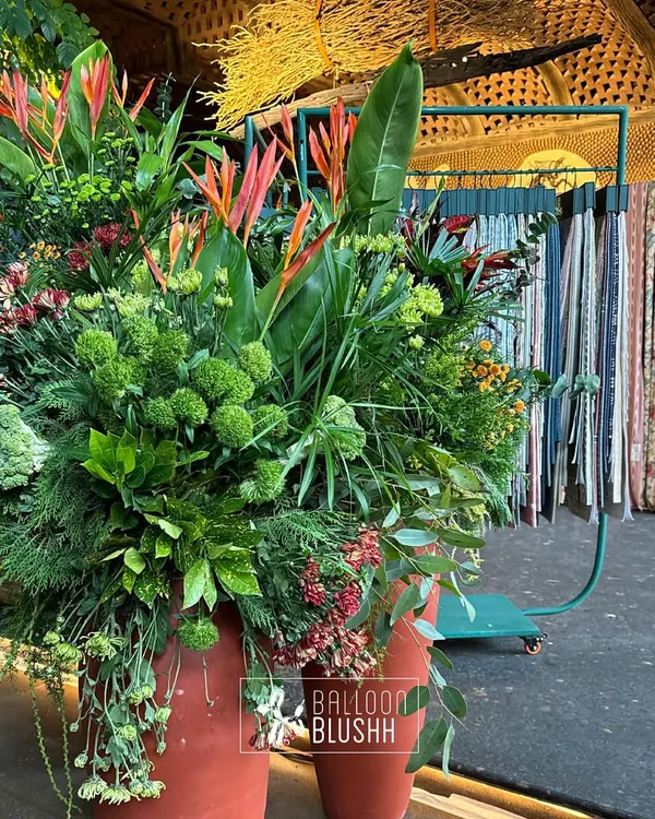We created this lush, tropical arrangement featuring birds of paradise and rich greenery for a home decor brand's event. This style of floral design is perfect for adding a touch of exotic elegance to any space.