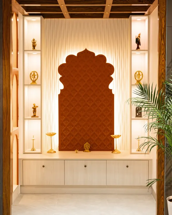 A beautifully lit pooja unit from my Hyderabad Experience Center. It features a traditional arch-shaped backdrop, backlit display shelves for idols, and concealed storage below.