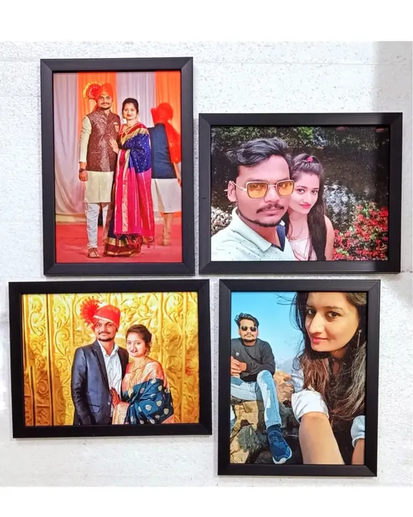A set of four matching black wall frames, each containing a different photo, creates a beautiful gallery wall. This set was made for a housewarming occasion.