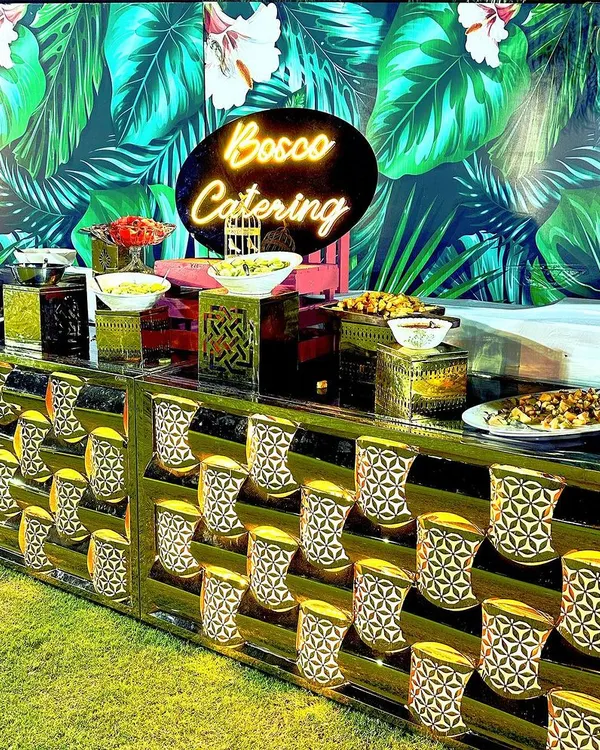 Our custom salad bar with a neon sign, set up for an outdoor event. We provide a variety of fresh vegetables, toppings, and dressings for a healthy and vibrant option.