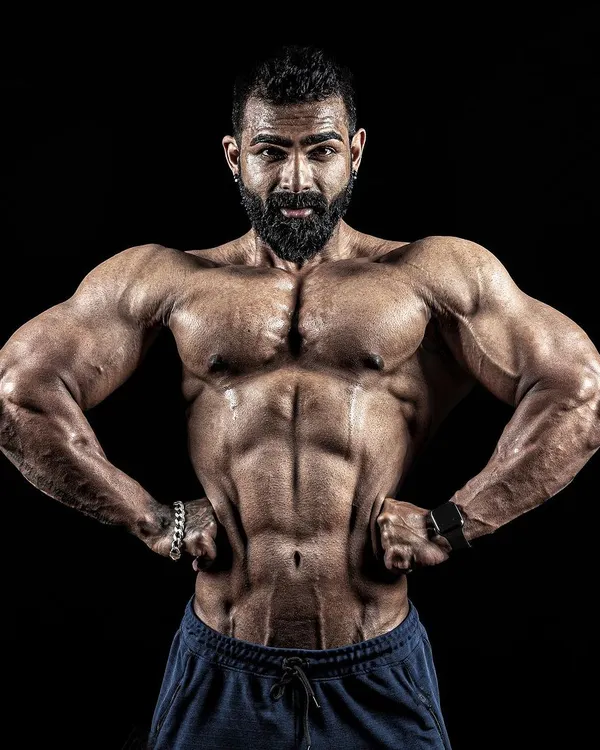 This is the result of habit. Motivation gets you started, but it's the daily discipline that carves out a physique like this. This front lat spread pose displays the width and definition built over years.