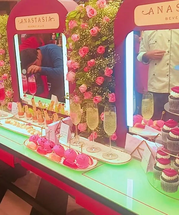 A whimsical dessert bar we created for Anastasia Beverly Hills. The display includes custom cupcakes with lipstick toppers, pink macarons, and sparkling beverages to match the brand's glamorous aesthetic.