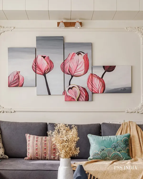 This multi-panel floral artwork adds a soft, artistic touch above the sofa. The piece is complemented by a mix of textured cushions and a cozy throw, demonstrating how art and textiles can work together.