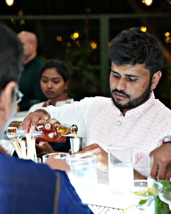 A close-up of one of our professional bartenders carefully measuring and pouring a spirit. This attention to detail ensures every cocktail is perfectly balanced and consistent.