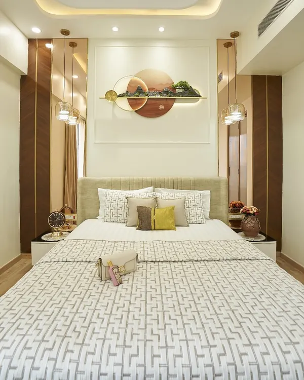 This bedroom is all about quiet confidence. The centerpiece is the unique 3D wall art above the bed, which is complemented by hanging pendant lights. The neutral color scheme with pops of yellow creates a calm yet cheerful space.