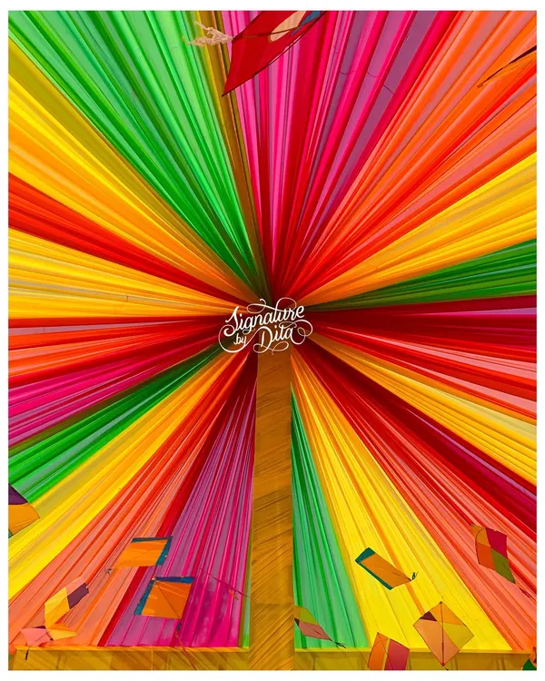 I love using fabric to transform a space. For this Holi party, I created a spectacular tented ceiling with radiating panels of vibrant color, decorated with kites to complete the festive look.