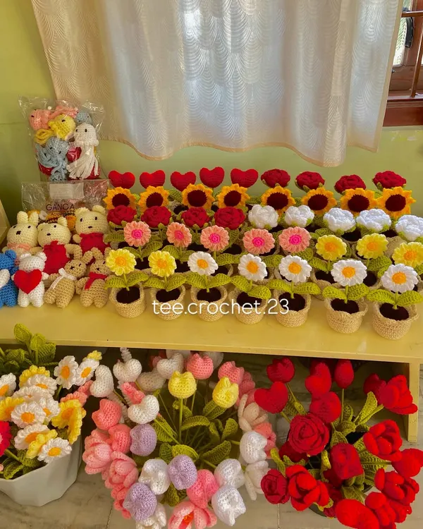 A beautiful display of my handmade crochet flowers and accessories. This shelf includes potted flowers, bouquets, and bunny keychains from a recent large order.