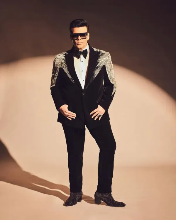 A striking black velvet tuxedo designed for making an entrance. This piece features dramatic silver beaded tassels on the shoulders, creating a look that is both powerful and elegant, perfect for a high-profile gala or a groom's reception outfit.