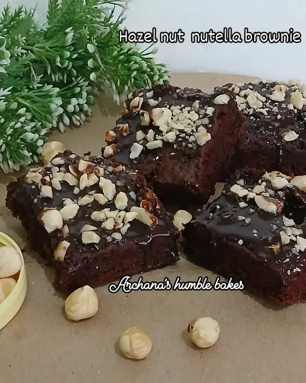 My Hazelnut Nutella brownies are a crowd favorite. These eggless brownies have a rich chocolate base, are topped with a layer of Nutella, and sprinkled with crunchy roasted hazelnuts.