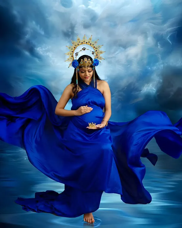 A portrait of pure power and grace. The deep blue gown flows like water, and the celestial crown adds a touch of divine energy, creating a truly breathtaking image of motherhood.
