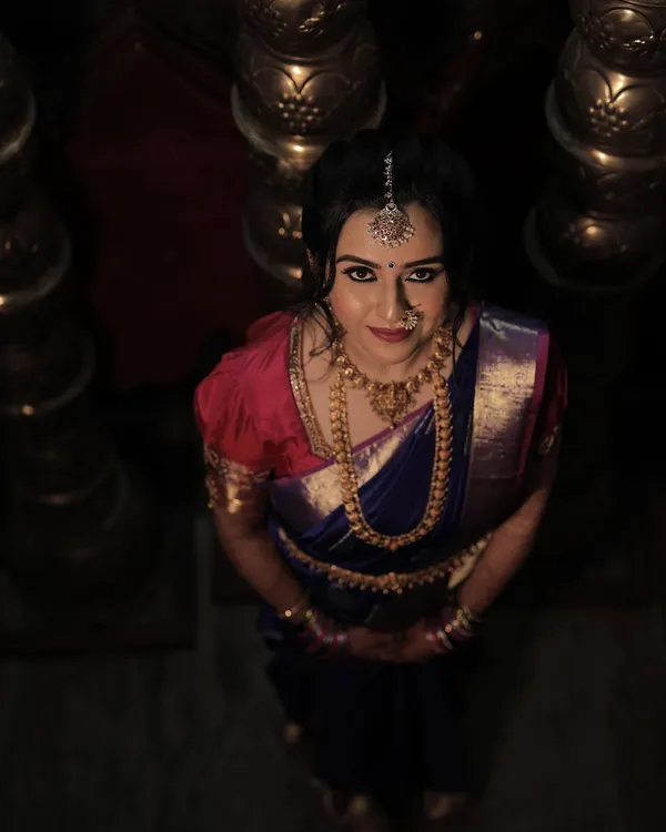 Chinmayi's varpooje look was absolutely captivating. We went for a dramatic smokey eye and a soft pink lip to complement her royal blue and pink Kanjeevaram saree.