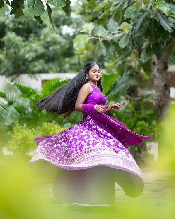 The perfect twirl in her custom purple Banarasi lehenga. The movement of the skirt shows off the rich fabric and intricate silver work.
