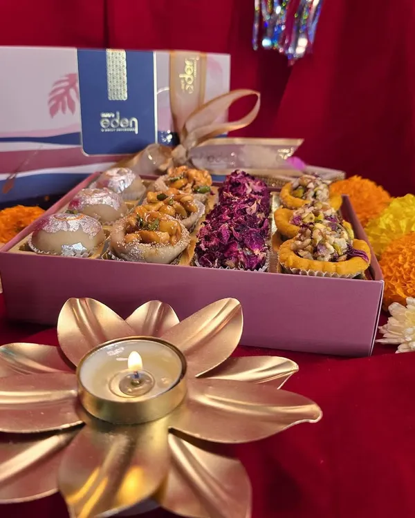 Embrace the blessings of the festive season with a box of my handcrafted sweets. This assortment, featuring rose petal and nut-topped mithai, is perfect for Laxmi Puja and Diwali celebrations.