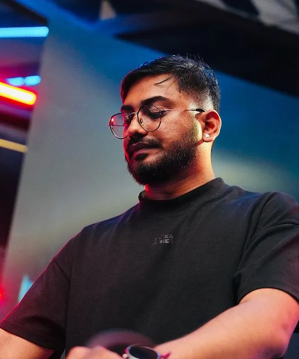 Lost in the music during a live set. This is me in my zone, completely focused on the rhythm and the energy of the room. Every performance is a journey, and I love guiding the crowd through it.