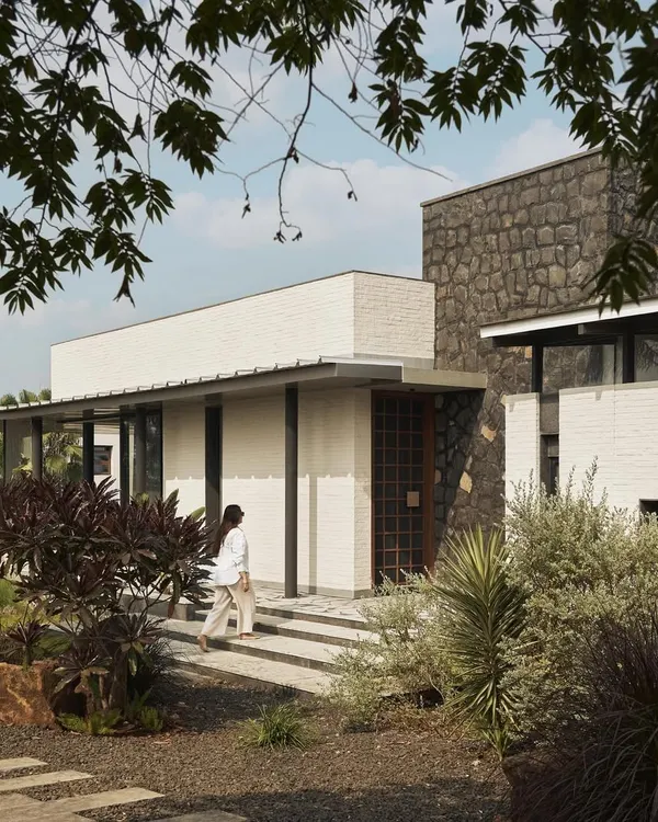 Introducing Pavilion House, set on a grassy expanse overlooking the backwaters of Lake Beze in Nashik. Inspired by prairie-style homes, its steel and glass composition is designed to establish a profound connection with the landscape, creating a true escape from the city.