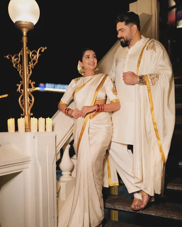 For their first Diwali, I designed these coordinated white and gold outfits for Tharun Sudhir and Sonal Monteiro. Her saree blouse and his kurta both feature the same custom hand-painted gold motif, creating a look that is connected and elegant.